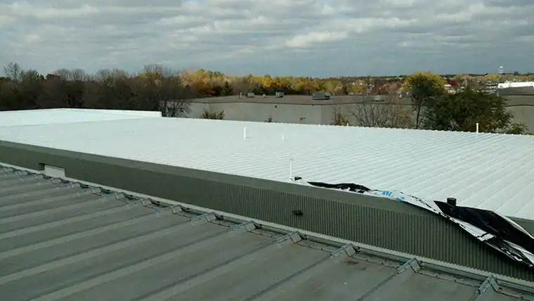 Green metal roof edge on an industrial building